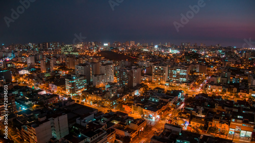 Panoramic night drone view over San Isidro District in Lima, Peru