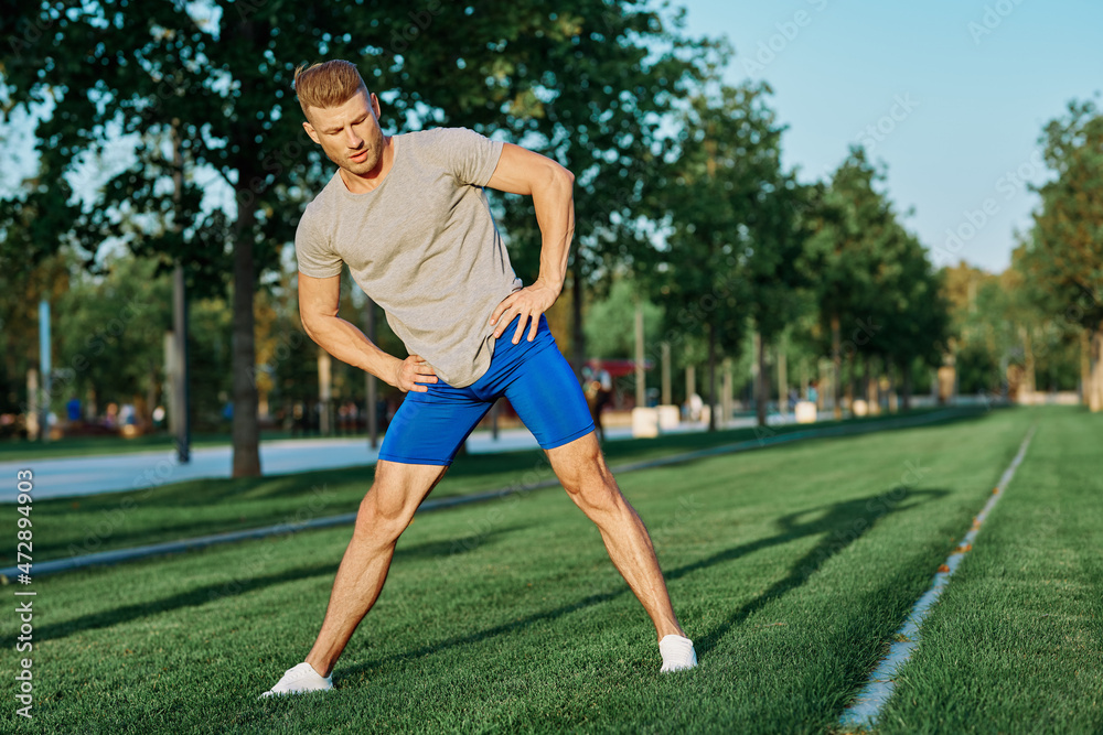 sporty man in the park on the lawn exercise lifestyle