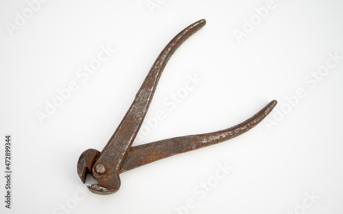 Rusty metal tongs on white isolate. An old hand tool. Vintage wire cutters.