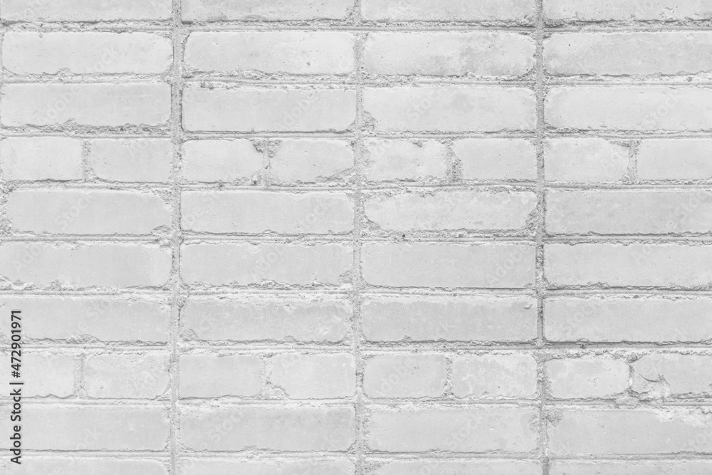 Obraz premium Non-standard irregular amateur brickwork blocks white stone wall texture background