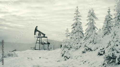 Day and night, in a severe frost and a snowstorm, a snowstorm in winter in Ukraine electric mountain pumps oil pump oil gas is a valuable raw material for energy 
 chemical industry