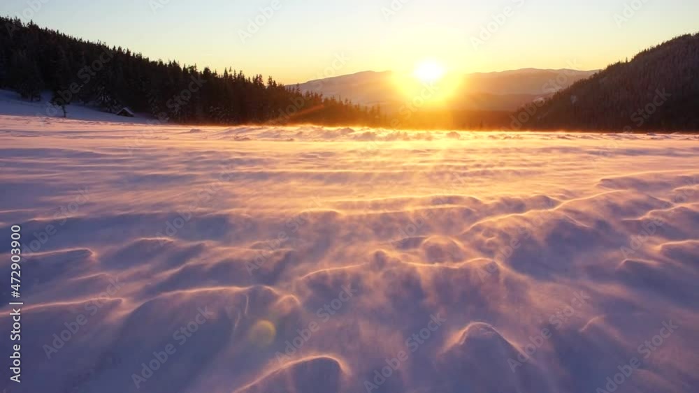 Snowy frosty peak in the Carpathians with beautiful scenery at sunset mountain range in extreme frosty weather with a hurricane wind and a dangerous snowstorm on the ice