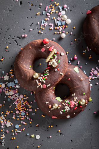 Homemade brownie donuts made of chocolate and sprinkles.