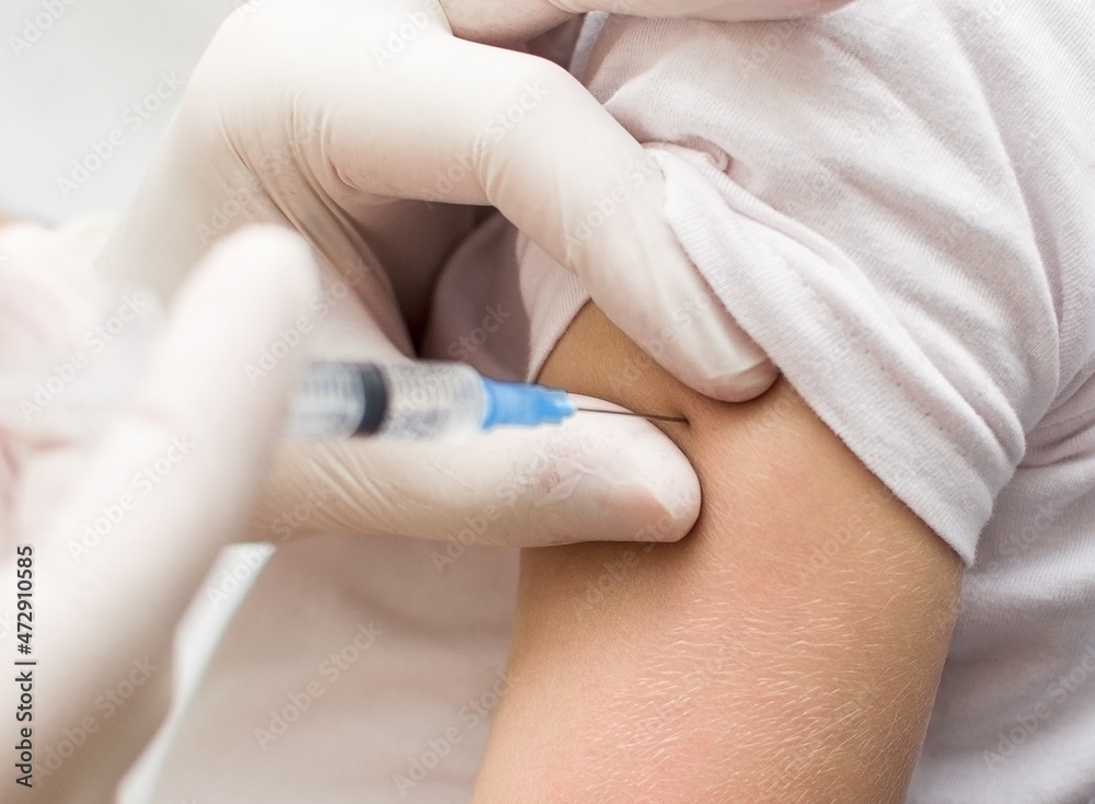 Close up of a Doctor making a vaccination in the shoulder of patient, Flu Vaccination Injection on Arm, coronavirus, covid-19 vaccine disease preparing for human clinical trials vaccination shot. Close up of a Doctor making a vaccination in the shoulder of patient, Flu Vaccination Injection on Arm, coronavirus, covid-19 vaccine disease preparing for human clinical trials vaccination shot.