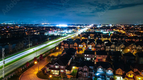 cars driving down city streets at night in Milton Ontario