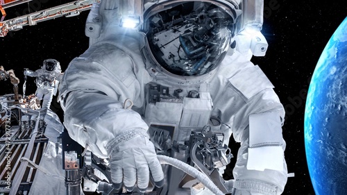 Astronaut spaceman do spacewalk while working for spaceflight mission at space station . Astronaut wear full spacesuit for operation . Elements of this image furnished by NASA space astronaut photos . photo