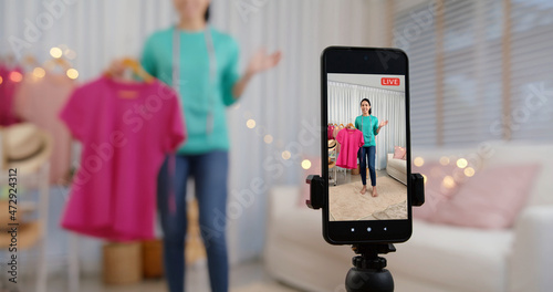 фотографія Asia vlogger woman influencer, SME retail store owner smile enjoy selling show live sale online screen in IG story reel tiktok work at home studio