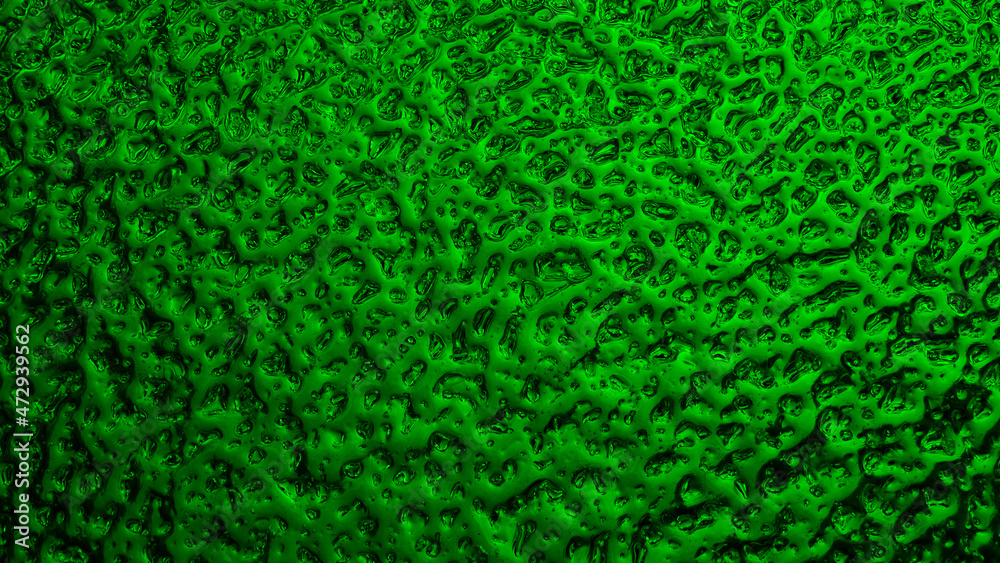 Bright green winter background. The surface of ice frozen on the window pane. An abstract pattern with a metallic sheen, like streams of mercury. Rich vivid wallpaper. Close-up Bright green winter background. The surface of ice frozen on the window pane. An abstract pattern with a metallic sheen, like streams of mercury. Rich vivid wallpaper. Close-up
