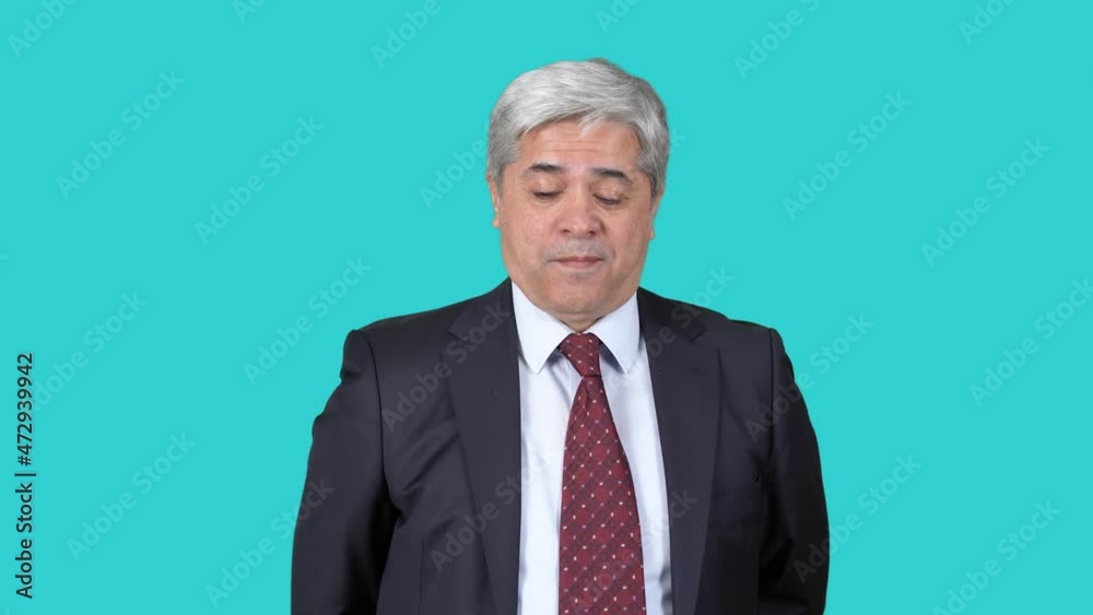 Man in suit looking up, approving.
Man in suit looks up with playful facial expression and nods while looking at camera. The background color is blue. Man in suit looking up, approving.
Man in suit looks up with playful facial expression and nods while looking at camera. The background color is blue.