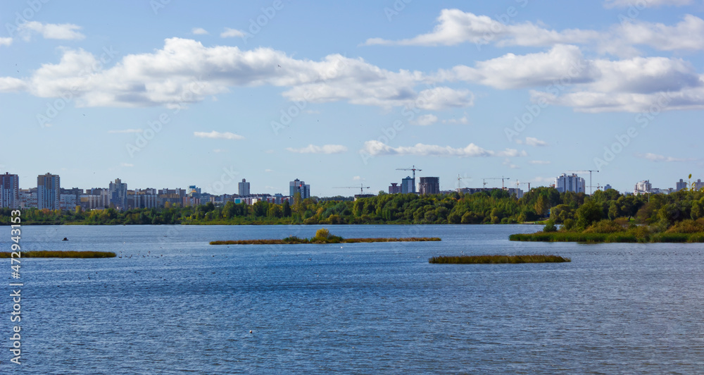 City landscape in early autumn. Lake overlooking the city in Europe