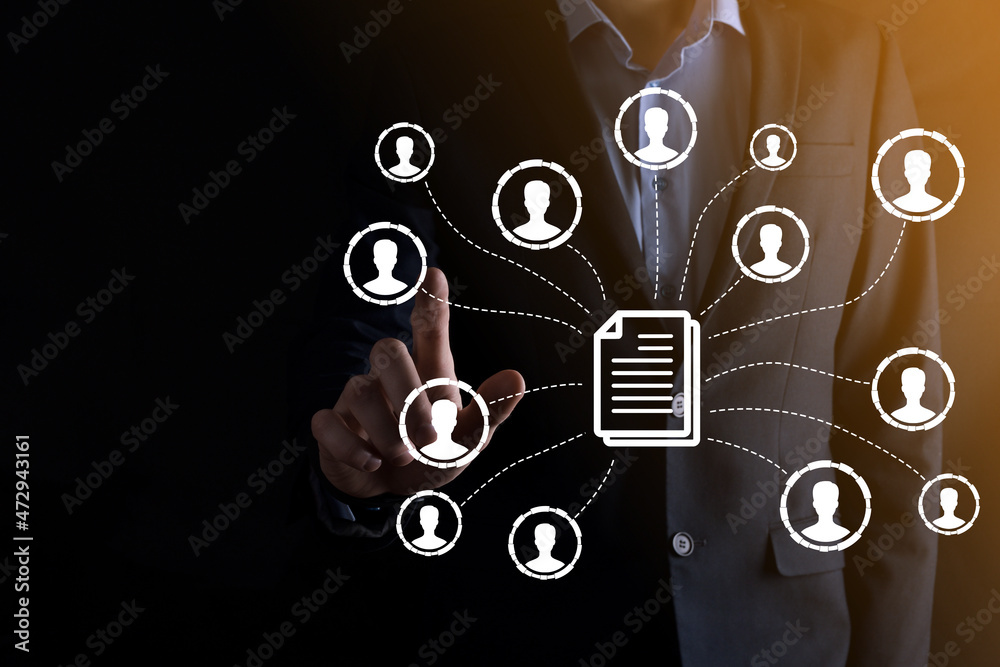 Fototapeta premium Man hold document and user icon.Corporate data management system DMS and document management system concept. Businessman click or publish on document connected with corporate users