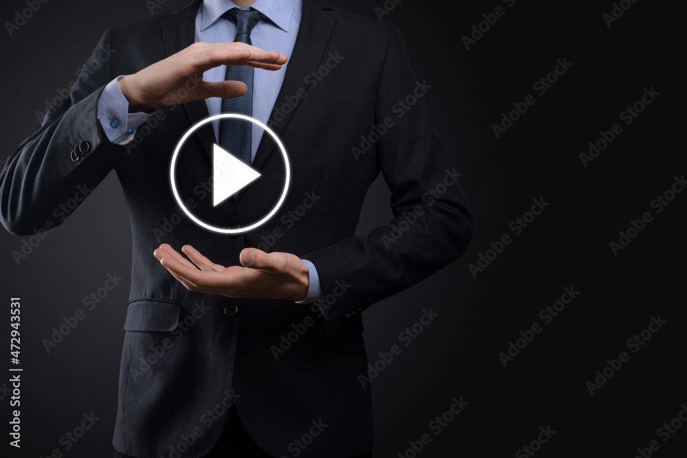 Businessman pressing, hold play button sign to start or initiate projects.Video Play Presentation. Idea for business, technology.media player button. Play icon.Go. Businessman pressing, hold play button sign to start or initiate projects.Video Play Presentation. Idea for business, technology.media player button. Play icon.Go.