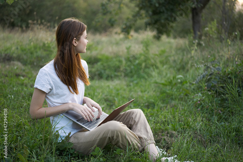 women outdoors in field with laptop leisure technology freedom © VICHIZH
