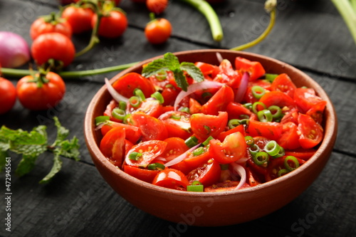Bowl of healthy and delicious organic tomato , onions salad. 