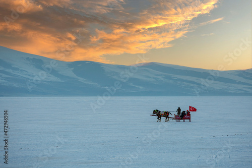 Kars - Turkey - March 6, 2018: Sleigh pulled by a horse in lake frozen Cildir. Traditional Turkish winter fun. Cildir Lake , Kars , Turkey © kenan