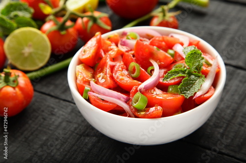 Bowl of healthy and delicious organic tomato , onions salad. 