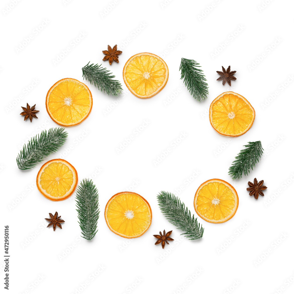 Christmas background. Slices of dried orange, anise and spruce branches on a white background Christmas background. Slices of dried orange, anise and spruce branches on a white background