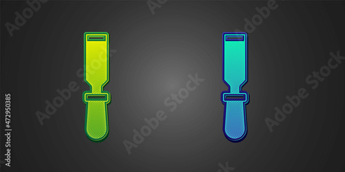 Green and blue Chisel tool for wood icon isolated on black background. Vector