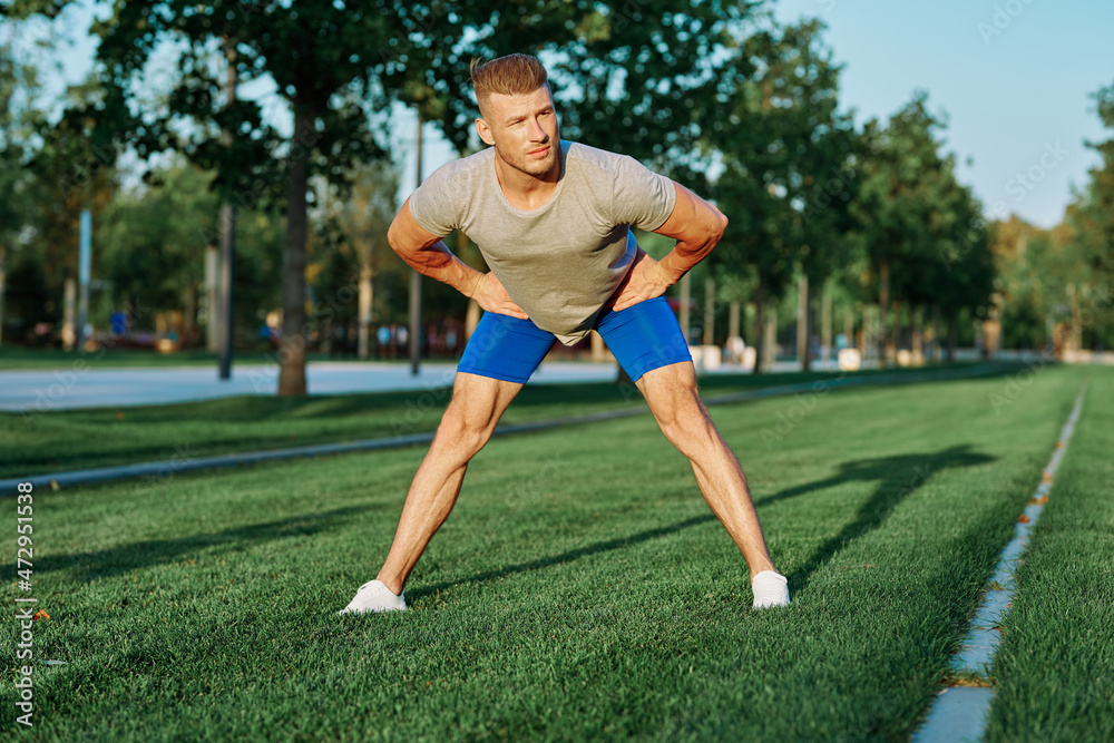 sporty man in the park on the lawn exercise lifestyle
