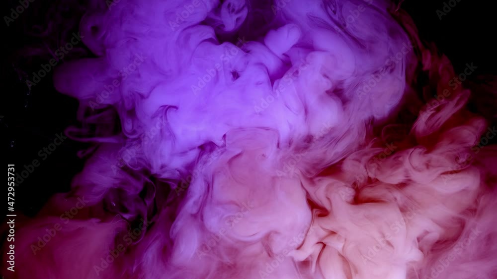 Pink paint creates abstract clouds. Artistic backgrounds. The fuchsia liquid swirls in beautiful clouds. Pink paint creates abstract clouds. Artistic backgrounds. The fuchsia liquid swirls in beautiful clouds.