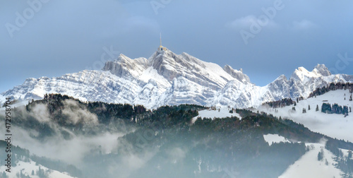 Stunning view of the famous Santis (Säntis) peak on a foggy winter day, eastern Switzerland photo