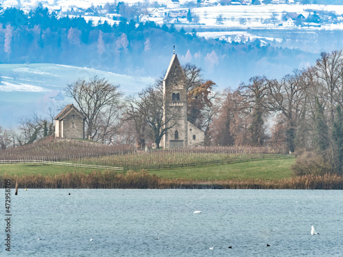 Idyllic landscapes and historical landmarks island, Lake Zürich, Schwyz, Switzerland. The medieval St. Peter & Paul church and St. Martin's chapel are surrounded by forests and vineyards.
 photo