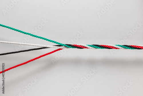 Unity and strength of Emirates- a concept for UAE National Day Celebration Day. Many cords with UAE National flag colors twisted together as one strong rope.