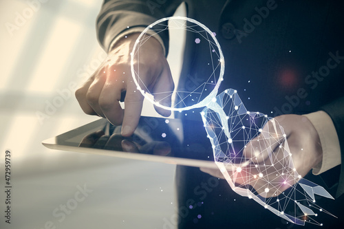 Double exposure of man's hands holding and using a mobile device and creative hologram drawing.
