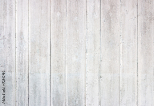 Old grey and white wooden background with cracks and scratches in vintage style