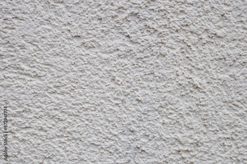 Plastered light wall. Background with irregular patches in the form of an asymmetrical pattern Plastered light wall. Background with irregular patches in the form of an asymmetrical pattern