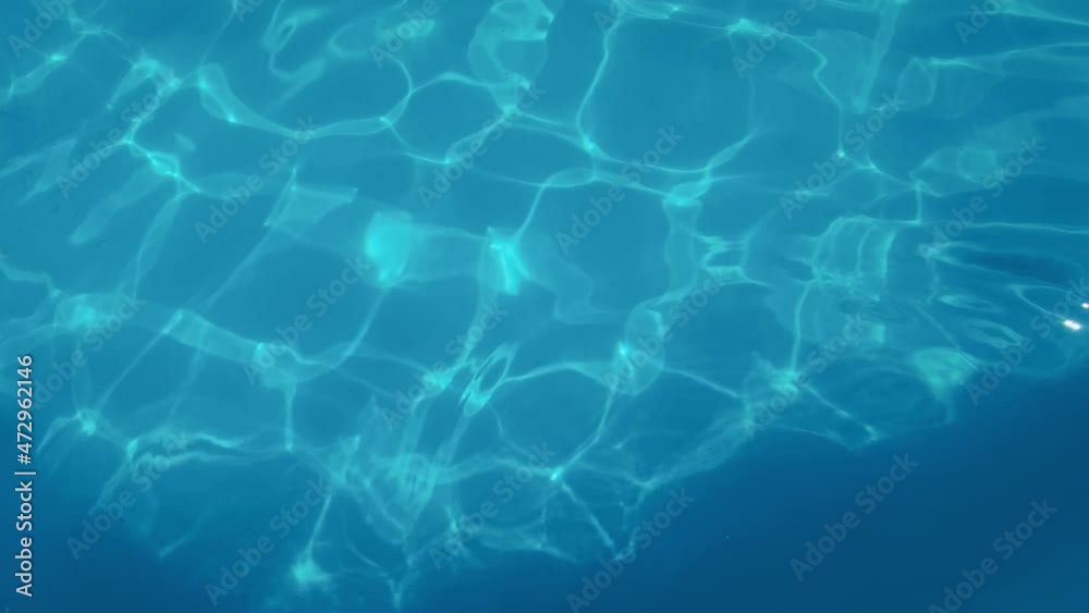 Water drop in swimming pool. Blue color. Ocean lockdown surface. Stop motion video. H2O hotel relax. Sea wave summer texture. Crystal wet waves. Float calm splash. Nobody liquid background Water drop in swimming pool. Blue color. Ocean lockdown surface. Stop motion video. H2O hotel relax. Sea wave summer texture. Crystal wet waves. Float calm splash. Nobody liquid background
