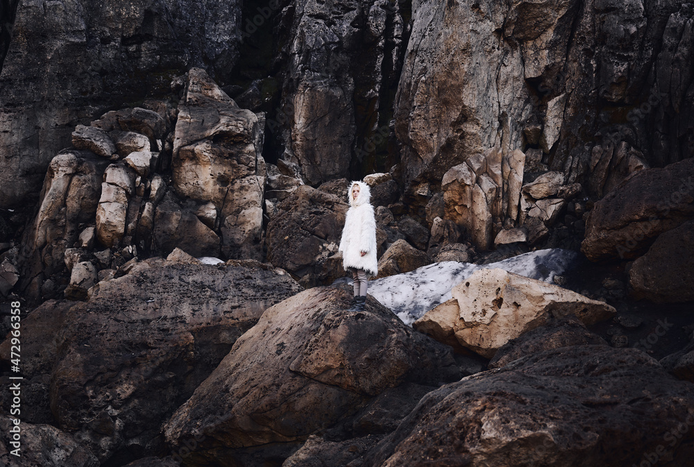 Fototapeta premium Fashion shooting in nature, a girl model in a fur coat made of artificial fur.