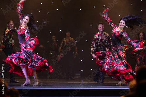 Fototapeta A team of musicians, singers and dancers in gypsy costumes singing and dancing o