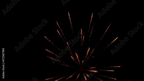 Volleys of fireworks against background of night black sky. Four volleys of yellow fire, one after other photo