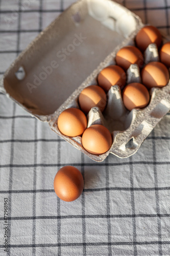 Few brown eggs among the cells of a large cardboard bag, chicken egg as a valuable nutritious product, a tray for carrying and storing fragile eggs. Not a full package of eggs, an important food item photo