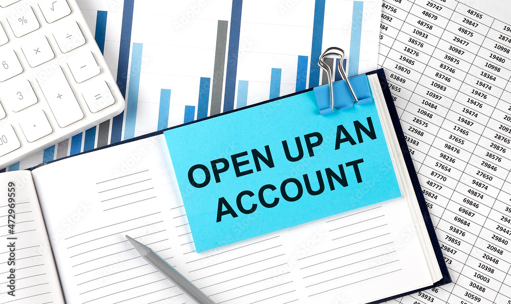 OPEN UP AN ACCOUNT text on blue sticker on the chart background near calculator