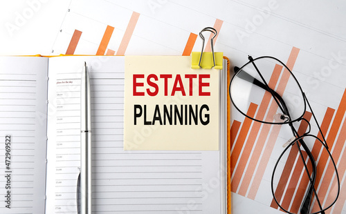 Text ESTATE PLANNING on sticker on the notepad on diagram background photo