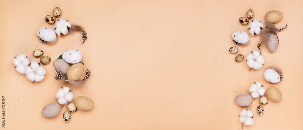 Obraz premium Easter eggs on beige pastel background with space for text. Flat lay image composition, top view.
