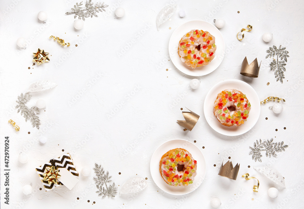 Roscon de reyes, spanish three kings Christmas sweet cake with winter decorations on white background Roscon de reyes, spanish three kings Christmas sweet cake with winter decorations on white background