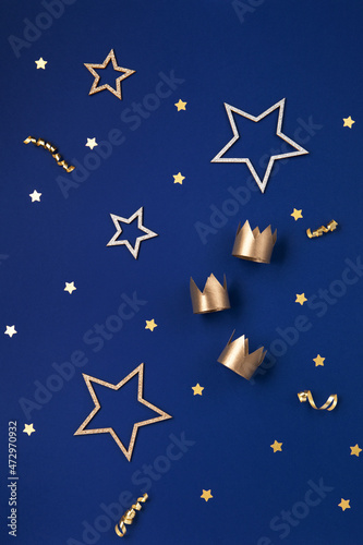 Three gold crowns for Traditional Three King's Day of January 6, blue background. photo
