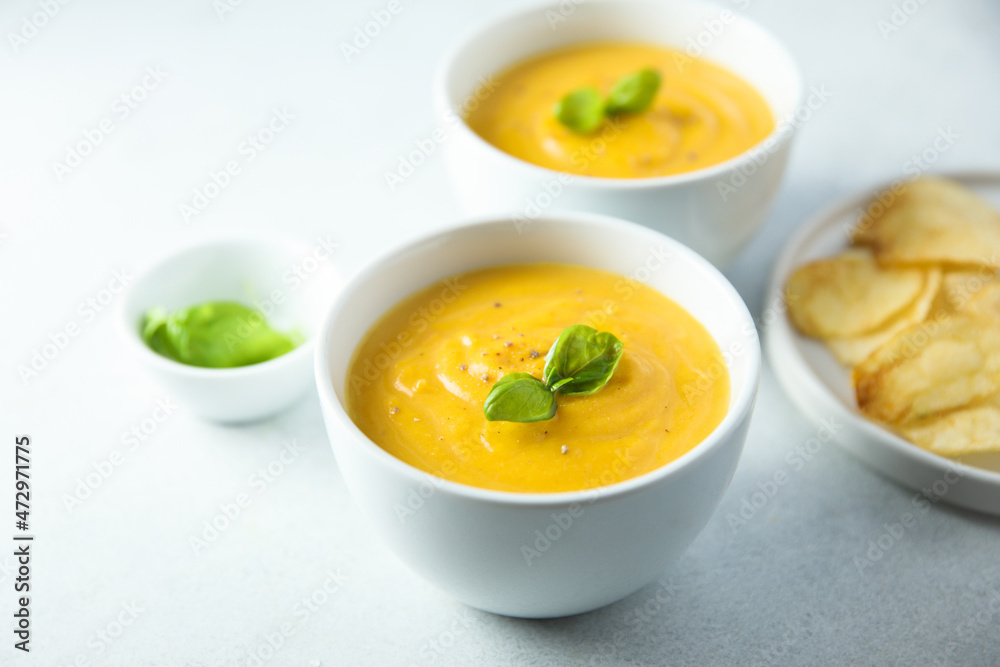 Traditional homemade pumpkin soup with fresh basil Traditional homemade pumpkin soup with fresh basil