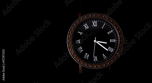 Men's watches with Roman numerals on a dark background. Stock photo with a place for the inscription