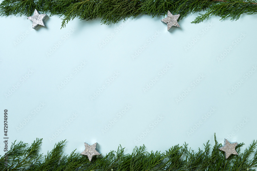 Obraz premium Christmas composition. Fir tree branches, decorations on blue background. Christmas, winter, new year concept. Flat lay, top view, copy space