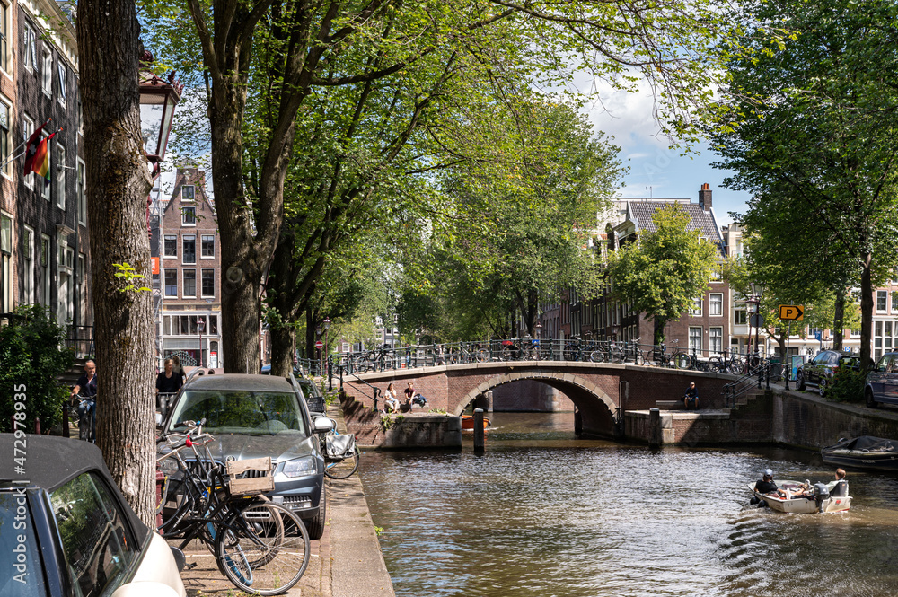 street view with buildings, greenery, sky and canals