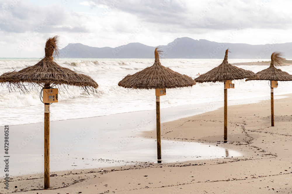 Beach umbrellas with water and sky