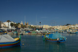 Port town with old buildings and waterfront in late summer in Malta, Marsaxlokk