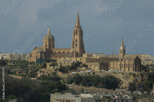 View to town from water sailing towards coast with old buildings in Malta, Gozo © Erol