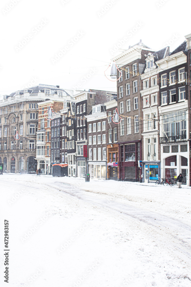 Fototapeta premium Snow covered streets with cold weather in Amsterdam, Netherlands