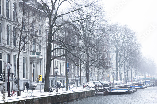Canvas Print Snow covered streets with cold weather in Amsterdam, Netherlands