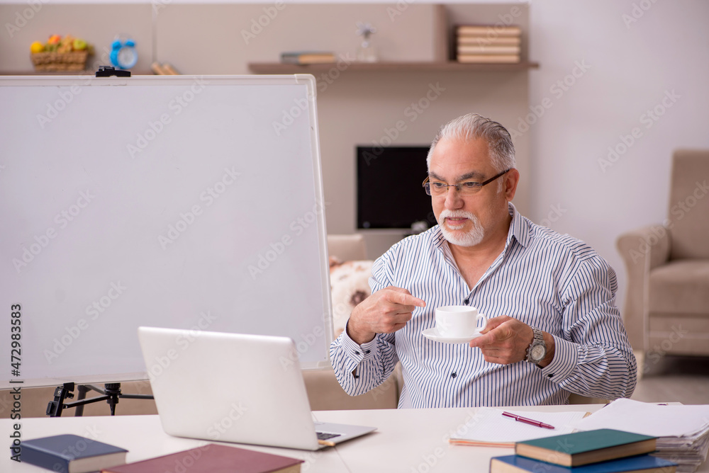 Old male employee working from home during pandemic Old male employee working from home during pandemic